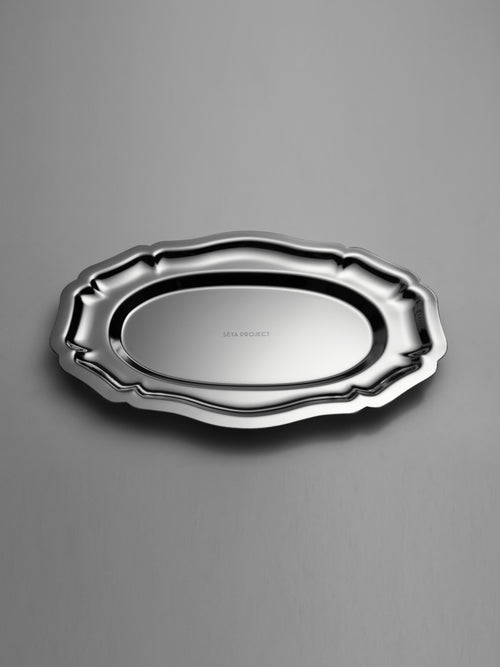 Oval stainless steel tray with decorative scalloped edges and polished finish.